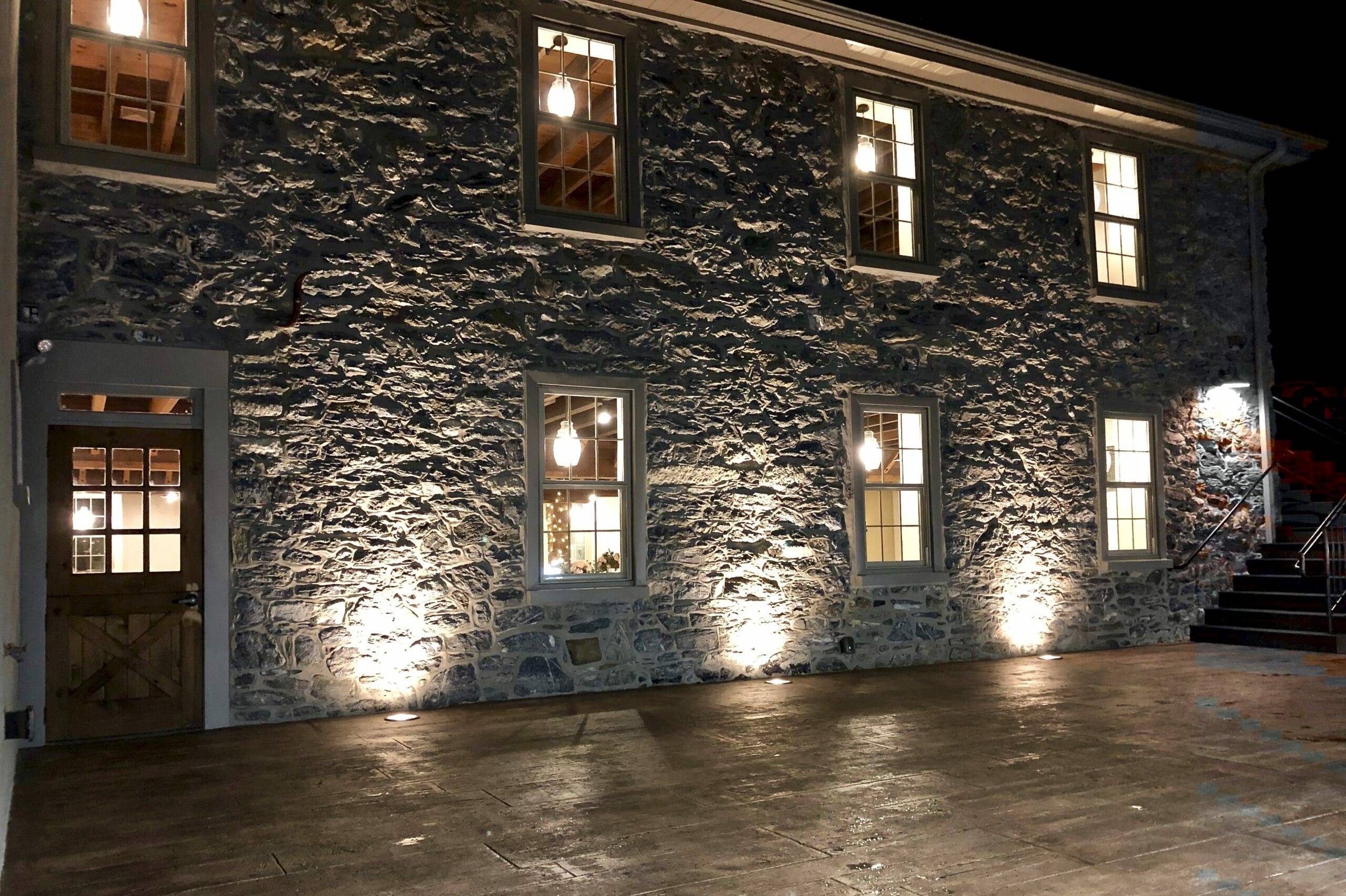 outside lit up stone building at night